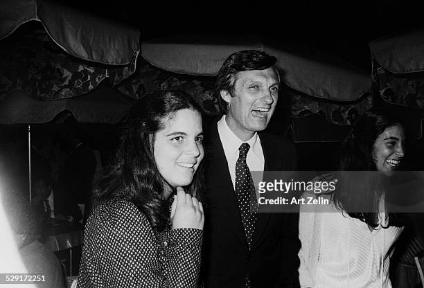 Alan Alda with his daughters, Elizabeth and Beatrice, at an outside event; circa 1970; New York.