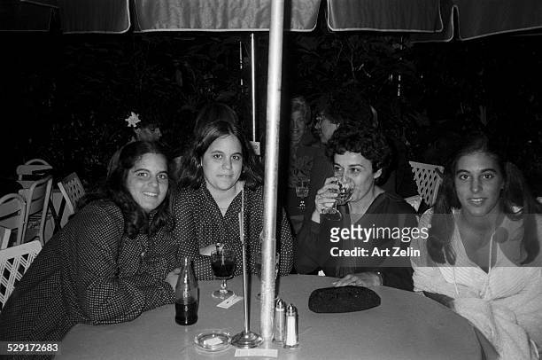 Alan Alda's daughters with their mother Arlene Alda at an outdoor party; circa 1970; New York.