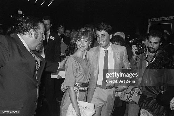 Matt Lattanzi and Olivia Newton-John walking through crowd to enter event, New York, circa 1983.