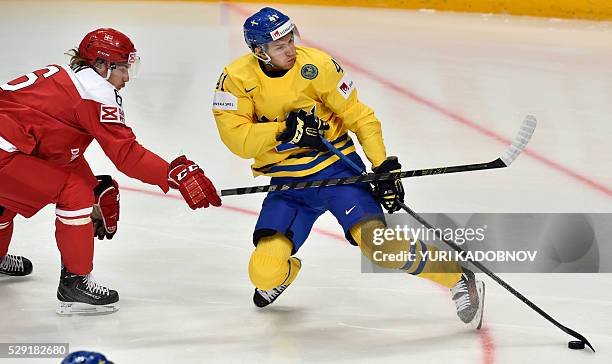 Denmark's defender Stefan Lassen vies with Sweden's forward Alexander Wennberg during the group A preliminary round game Sweden vs Denmark at the...