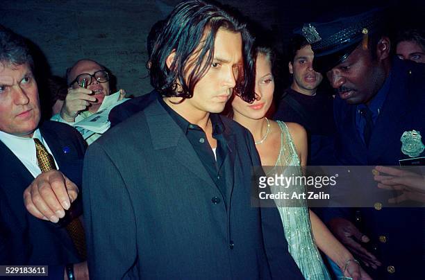 Kate Moss with Johnny Depp with security; circa 1990; New York.