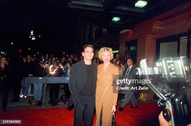 Cameron Diaz with Matt Dillon on the red carpet, photographers in the background; circa 1990; New York.