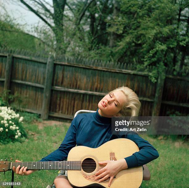 Joey Heatherton playing guitar in her backyard. Rockville Centre, Long Island, NY. 17 years old.