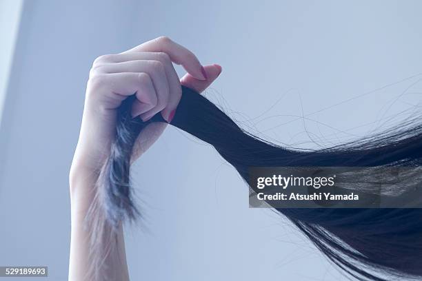 beautiful asian woman touching her hair - hand in hair foto e immagini stock