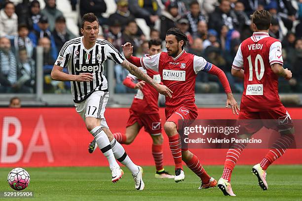 Mario Mandzukic of Juventus FC is challenged by Cristian Zaccardo of Carpi FC during the Serie A match between Juventus FC and Carpi FC at Juventus...