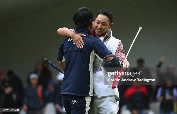 Jeunghun Wang of Korea celebrates with is caddie after holing the winning putt on the second hole of the play-off at the Trophee Hassan II at Royal...