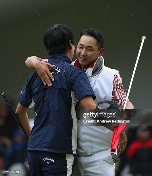 Jeunghun Wang of Korea celebrates with is caddie after holing the winning putt on the second hole of the play-off at the Trophee Hassan II at Royal...