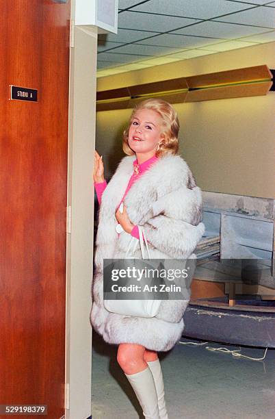 Sandra Dee, standing, posing for the photographer, wearing a gray and white fur; circa 1970; New York.