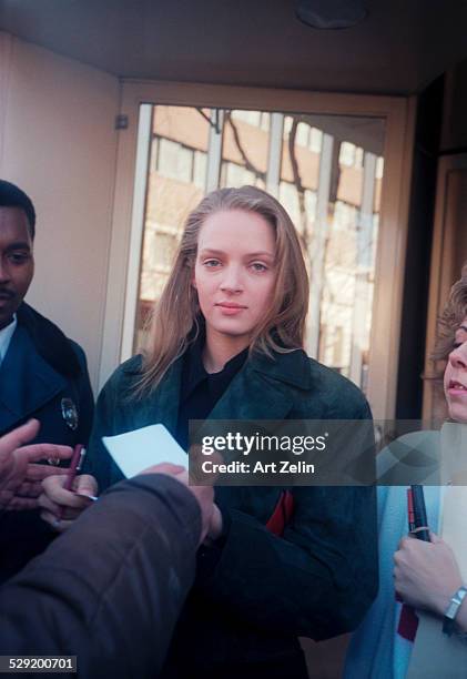 Uma Thurman signing autographs; circa 1990; New York.