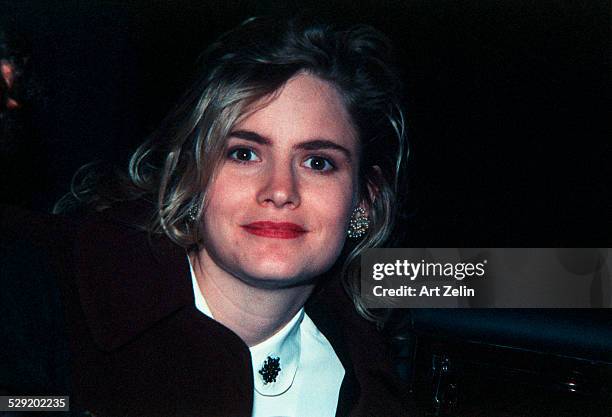 Jennifer Jason Leigh, close-up, with a car in the background; circa 1990; New York.