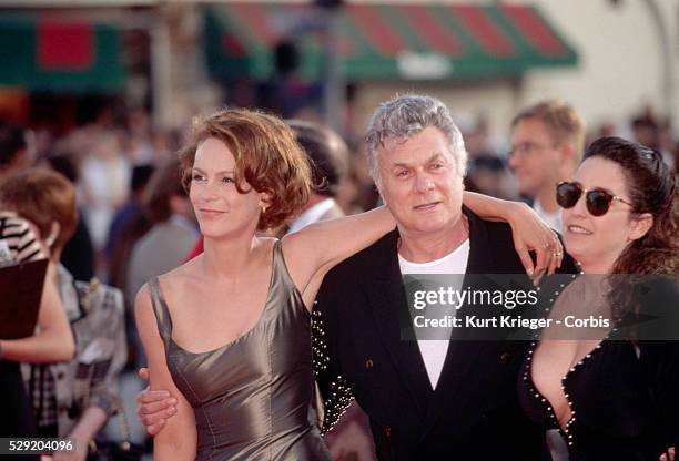 Actor Tony Curtis attends an awards ceremony in Hollywood with his daughter Jamie Lee Curtis and his wife Lisa Deutsch.