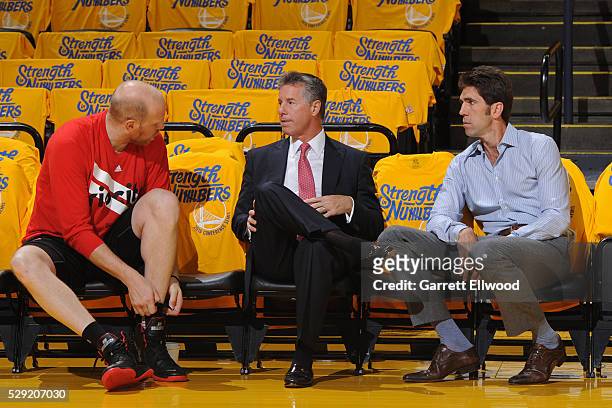Bob Myers general manager of the Golden State Warriors talks with Neil Olshey general manager of the Portland Trail Blazers in Game Two of the...