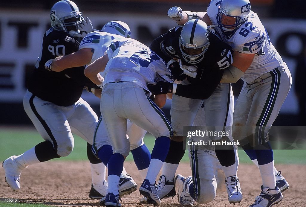 Rod Coleman Rod Coleman of the Oakland Raiders gets pulled down by Chris Gray of ...