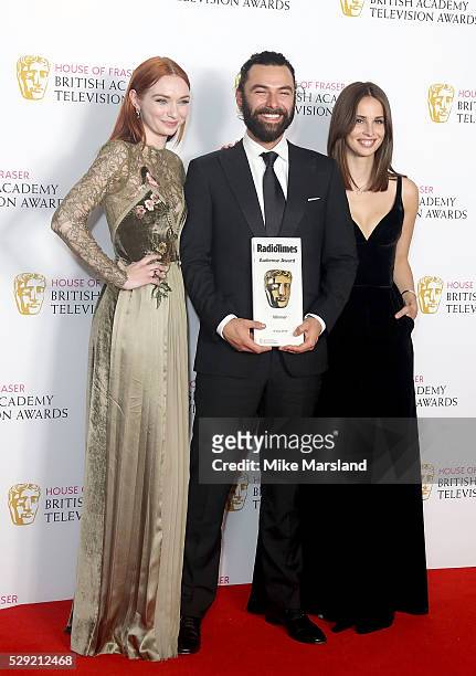 Eleanor Tomlinson, Aidan Turner and Heida Reed, accepting the Radio Times BAFTA Audience Award for 'Poldark', pose in the winners room at the House...