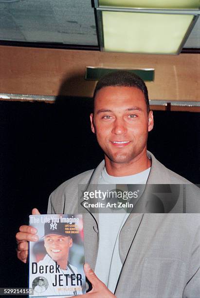 Derek Jeter with his book, "The Life You Imagine", 2001 ; circa 1990; New York.