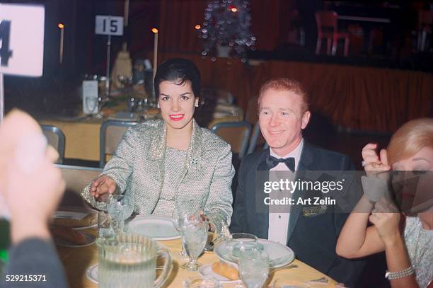 Red Buttons and Jane Russell at a formal dinner. He sang "Strange Things are Happening"; circa 1970; New York.