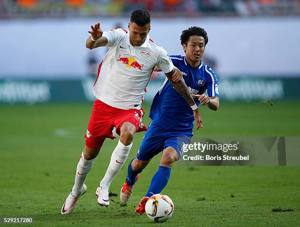 Davie Selke of Leipzig is challenged by Hiroki Yamada of Karlsruhe during the Second Bundesliga match between RB Leipzig and Karlsruher SC at Red...