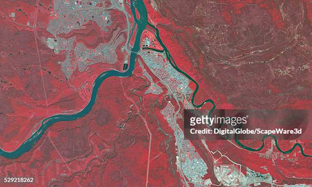 DigitalGlobe via Getty Images BEFORE infrared satellite image of Fort McMurray in Alberta before the devastating wildfire hit the town. Image was...