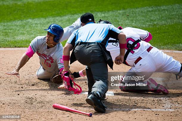 Home plate umpire Quinn Wolcott watches as catcher Yan Gomes of the Cleveland Indians tags out Cheslor Cuthbert of the Kansas City Royals during the...