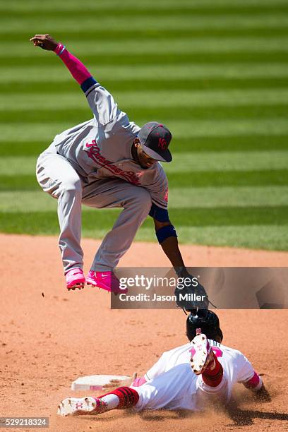 Shortstop Alcides Escobar of the Kansas City Royals tries to tag Francisco Lindor of the Cleveland Indians as he steals second during the fifth...