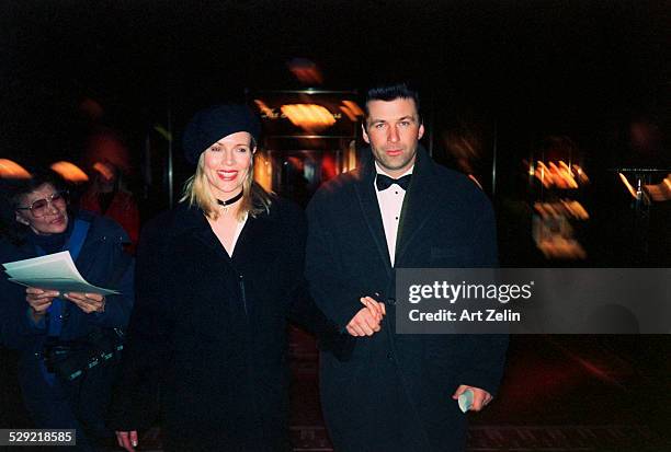 Alec Baldwin with Kim Basinger, walking together holding hands ; circa 1990; New York.