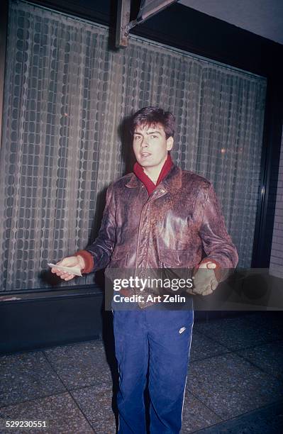 Charlie Sheen in a leather jacket and red scarf; circa 1970; New York.