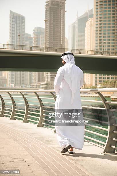 sheikh talking and walking togetherness on the city - arab man walking stock pictures, royalty-free photos & images