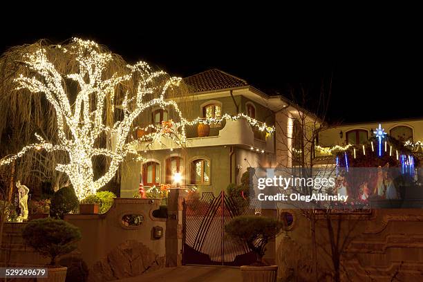 luxury brooklyn house with christmas lights at night, new york. - dyker heights stock pictures, royalty-free photos & images