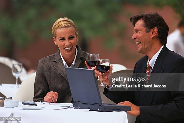 business people with wine and laptop - business man laughing stock pictures, royalty-free photos & images