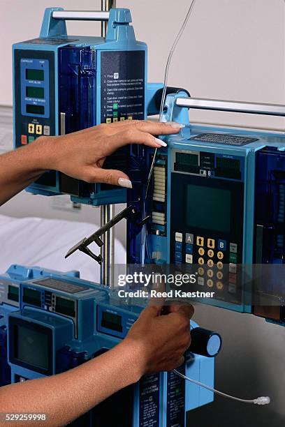 nurse setting up iv regulator - infusion pump stock pictures, royalty-free photos & images