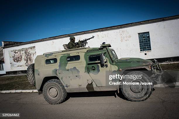 Russian solder watches resupply trucks enter the base at the Perevalnoye base outside of Simferopol, Crimea The majority of the population is pro...