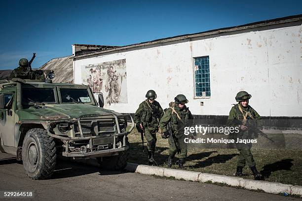 Russian solder watches resupply trucks enter the base at the Perevalnoye base outside of Simferopol, Crimea The majority of the population is pro...