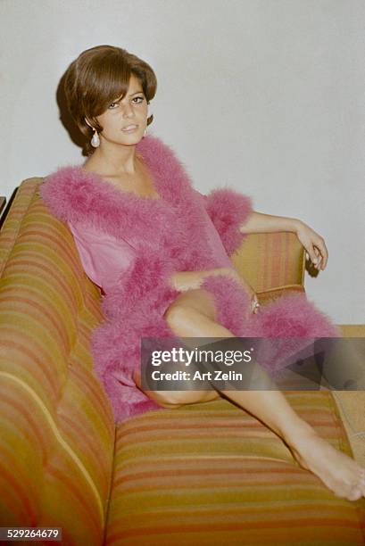 Claudia Cardinale in a feather trimmed negligee; circa 1970; New York.