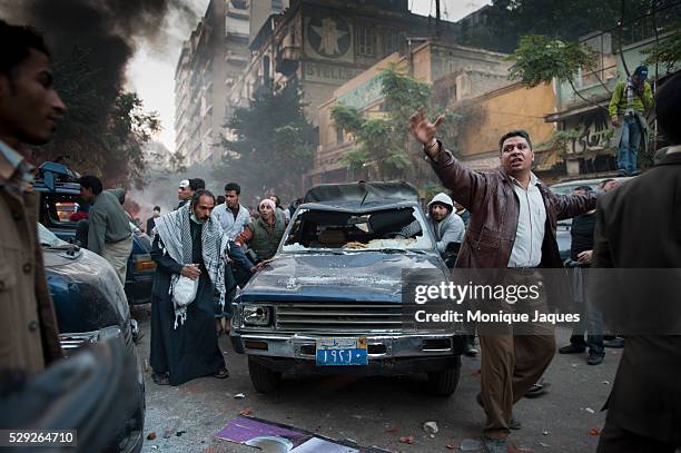 Protesters trash a police vehicle as a sign of the distrust with the goverment and violence inflicted by police members. Despite tear gas and rounds...