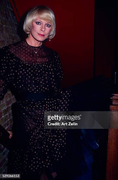 Elke Sommer in a formal dress on a stairway; circa 1970; New York.