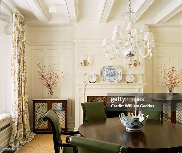 round dining table with leather upholstered chairs - sconce stock pictures, royalty-free photos & images