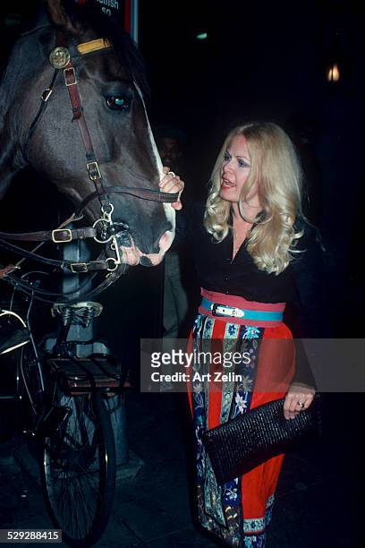 Sally Struthers petting a horse; circa 1970; New York.