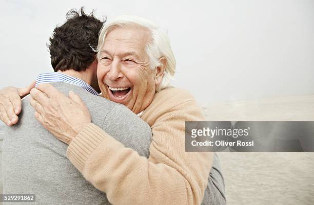 father and son hugging - old man son stock pictures, royalty-free photos & images