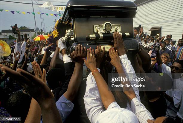 friends passing casket through neighborhood - african american funeral stock-fotos und bilder