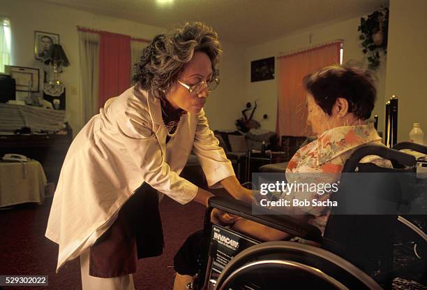 nurse tending to acupuncture patient - acupuncture elderly stock pictures, royalty-free photos & images