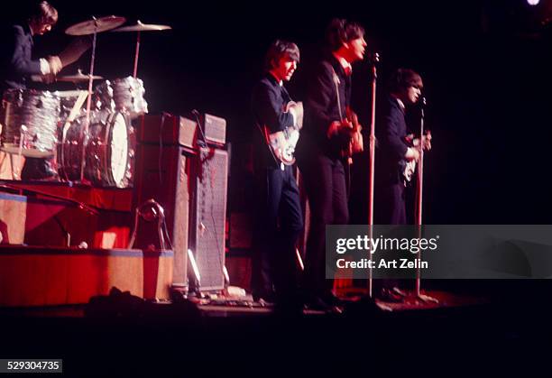 The Beatles on stage in concert; circa 1970; New York.