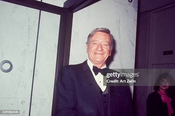 John Wayne in a tux; circa 1970; New York.