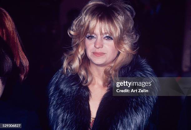 Goldie Hawn wearing a fur coat smiling for the photographer; circa 1970; New York.