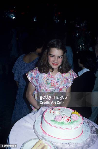 Brooke Shields with a cake; circa 1970; New York.