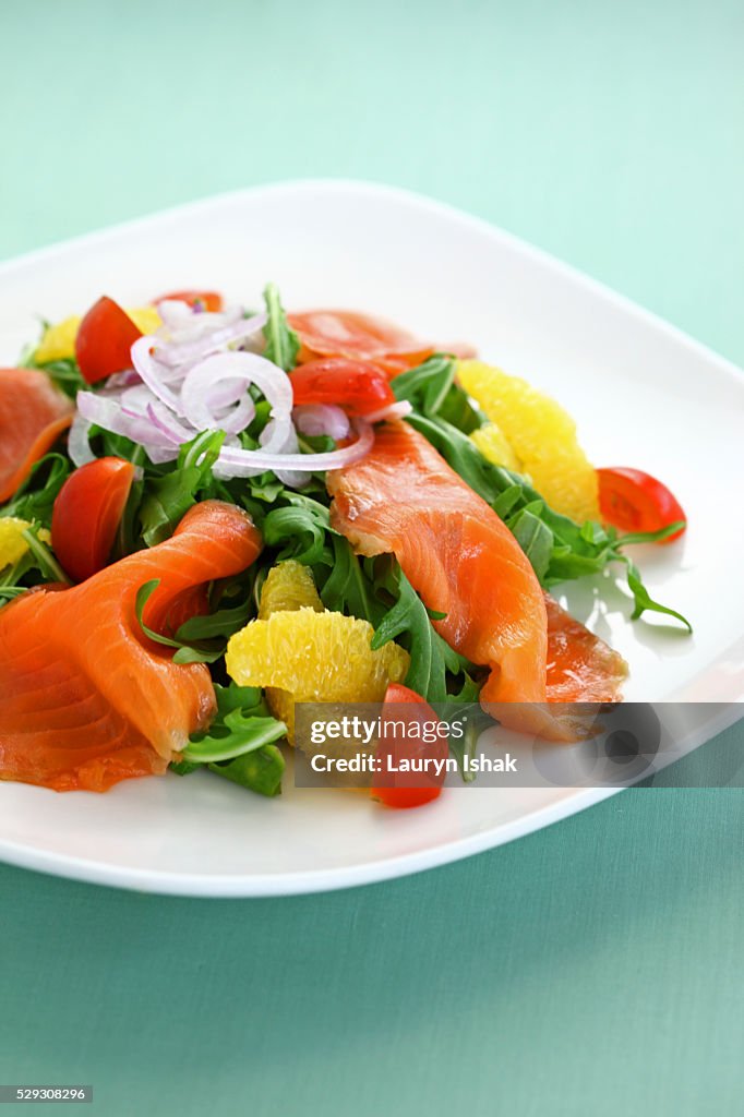 Smoked salmon with Arugula, dressed with onions, tomatoes and oranges