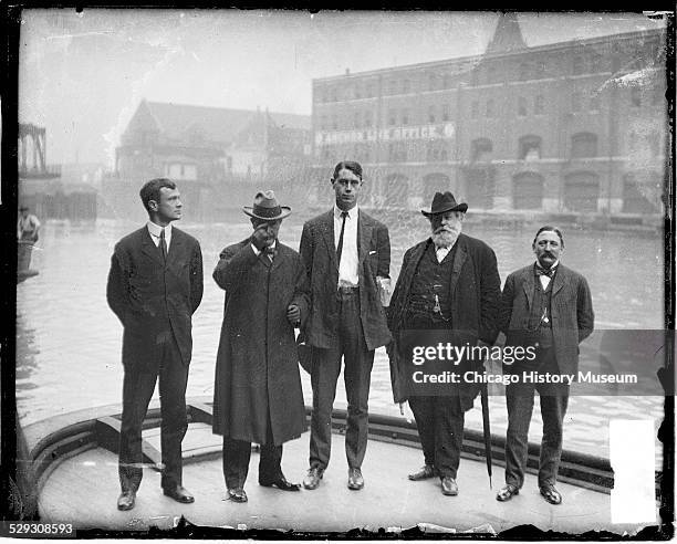 Portrait of Richard O'Sullivan Burke, ex-mayor Edward F. Dunne, Col. Robert R. McCormick, and Joseph M. Patterson standing on a boat on the Chicago...