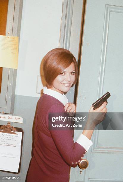 Claudia Cardinale holding a prop gun; circa 1970; New York.