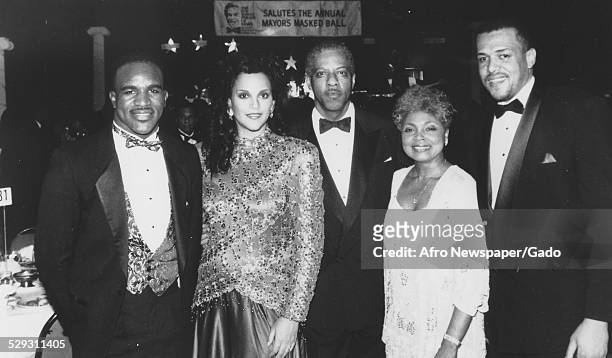 Heavyweight boxing champion Evander Holyfield and actress Jayne Kennedy-Overton at a United Negro College Fund event, 1980.
