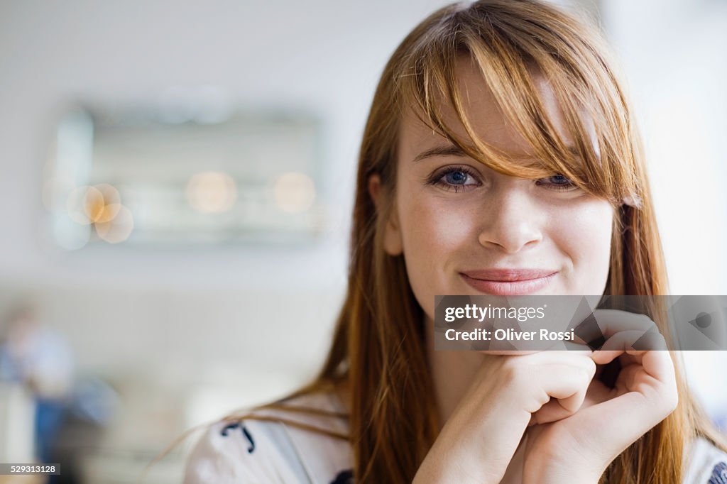 Young redheaded woman in cafe