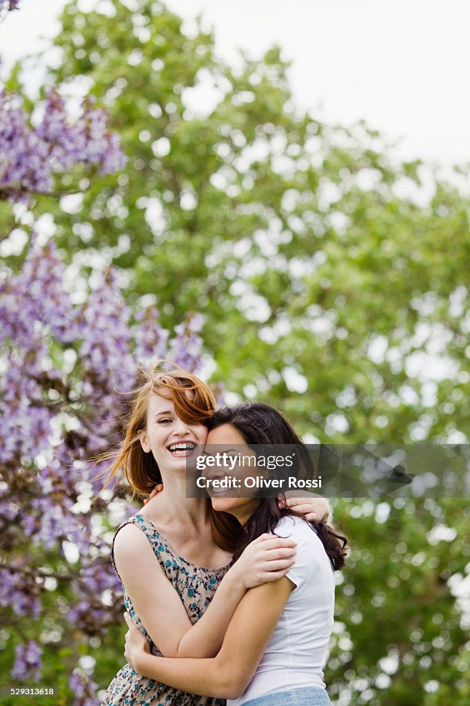 Young women hugging outdoors